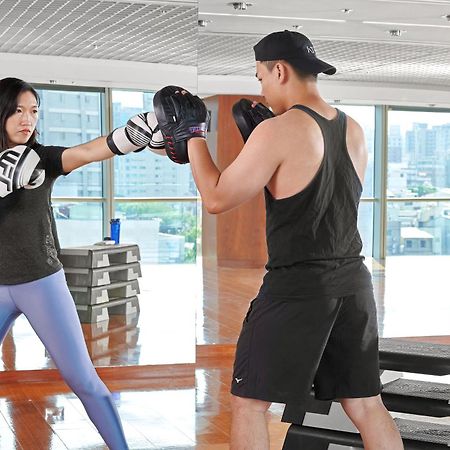 Windsor Hotel Taichung Exterior foto A woman and a man training in a gym